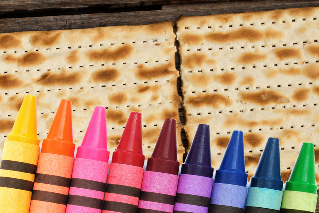 Multicolored crayons on matzah