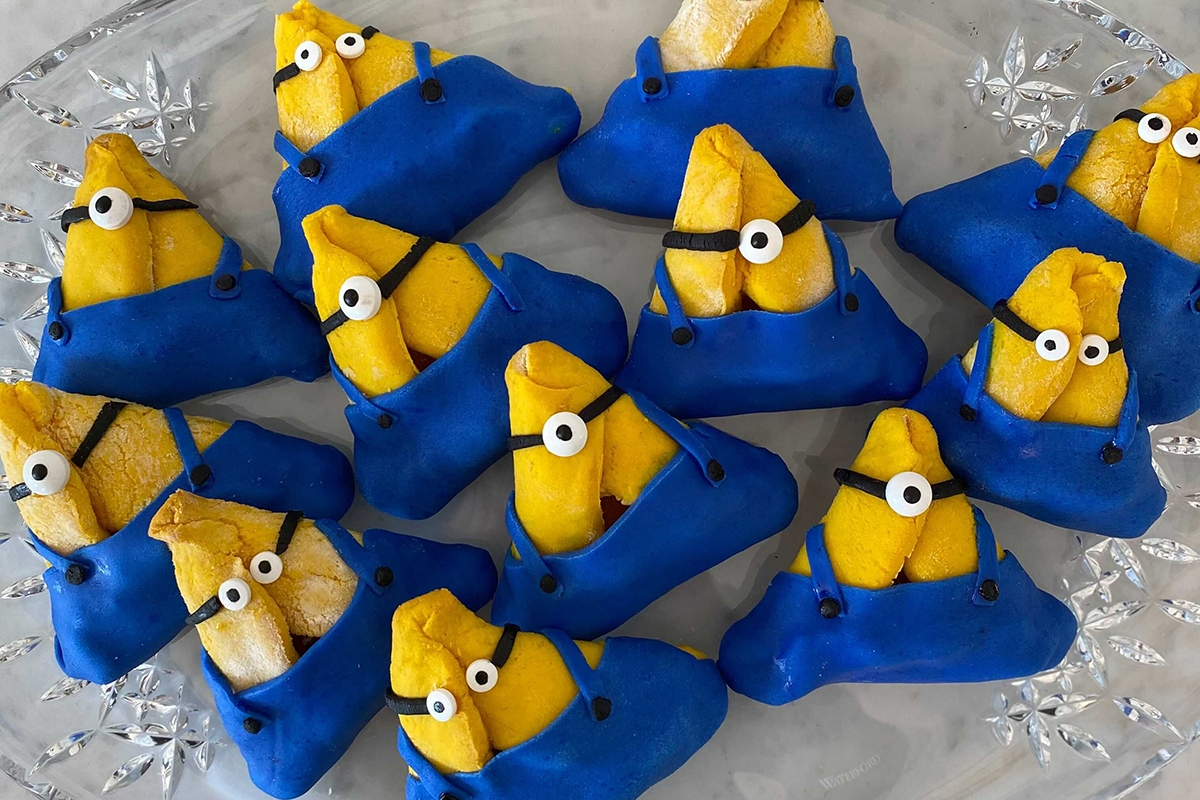 a plate full of hamantaschen that look like minions