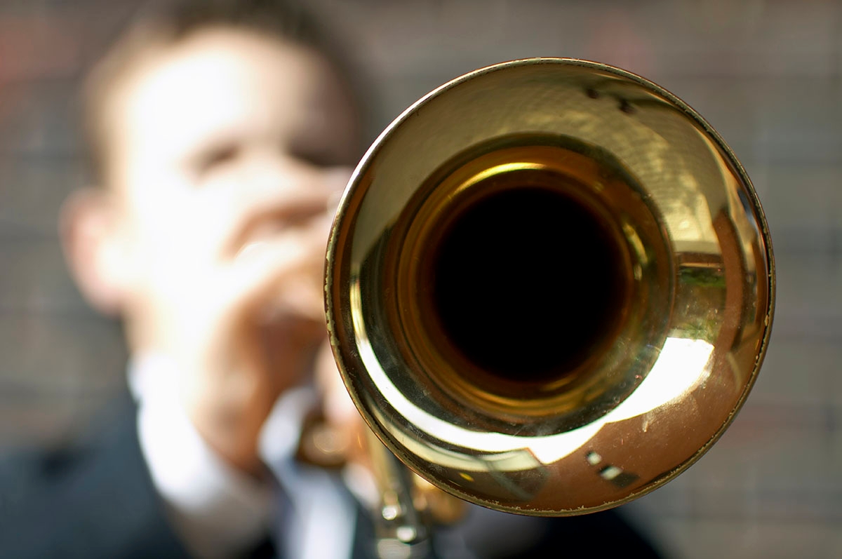 Boy playing trumpet.