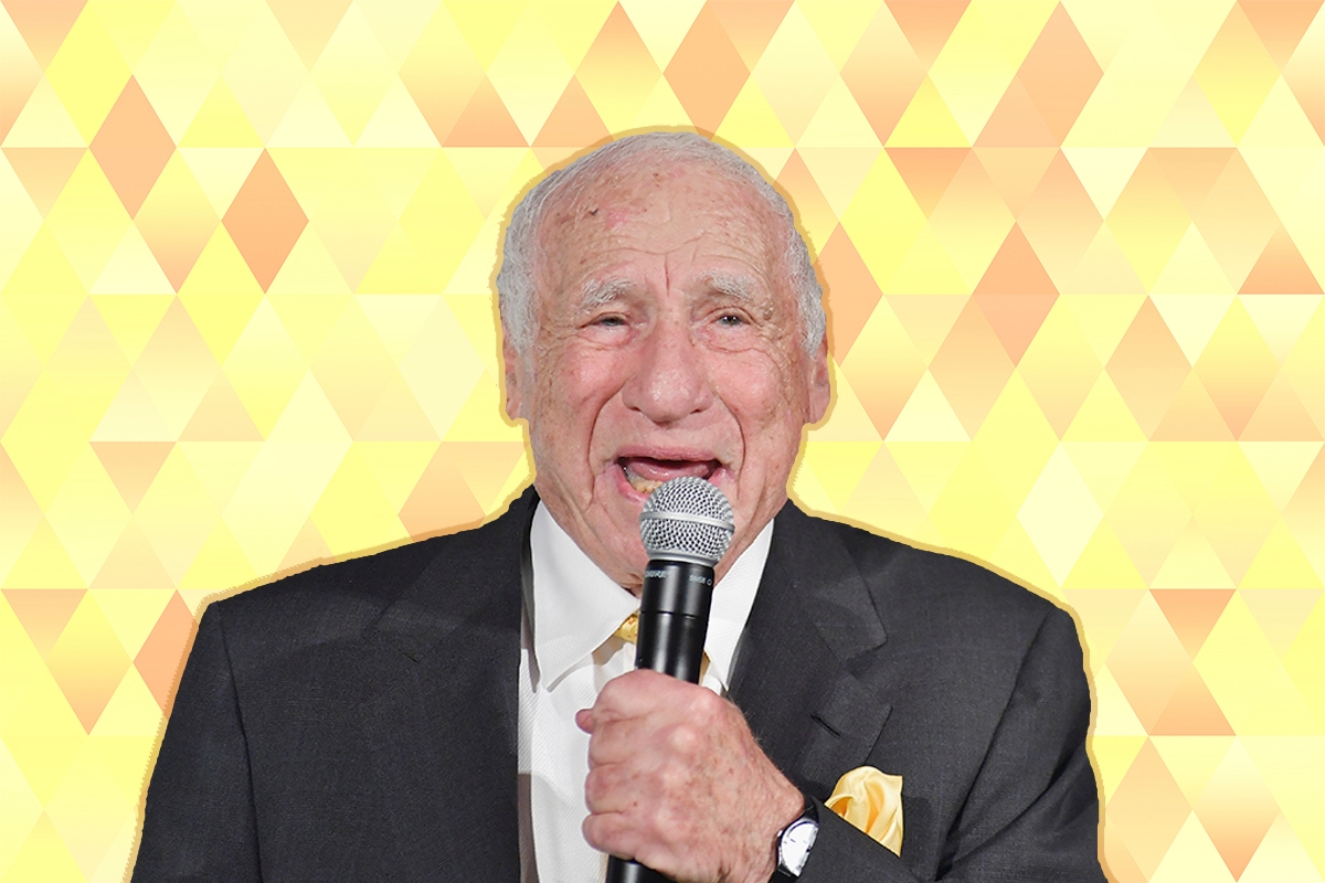 Mel Brooks speaking into a microphone.