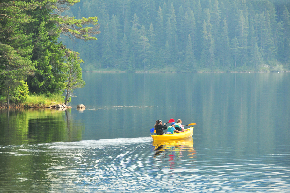 Kids kayaking on a lake.