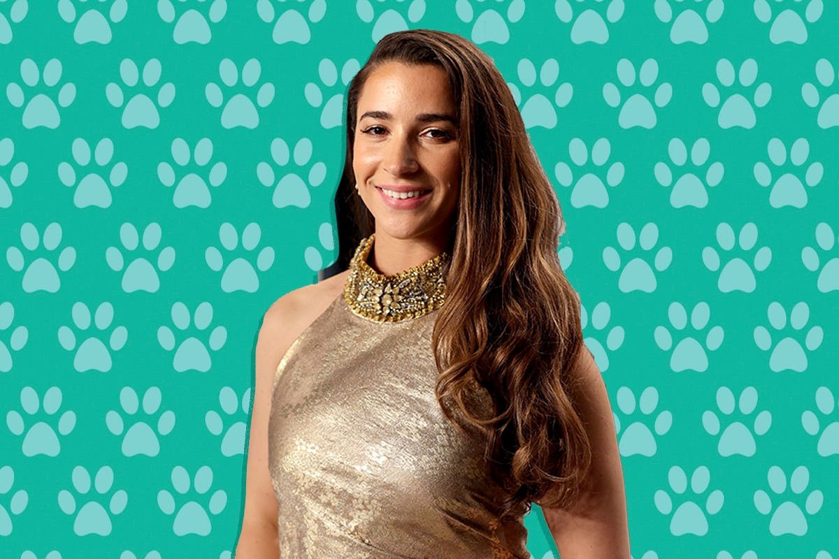 Aly Raisman in front of a paw print background