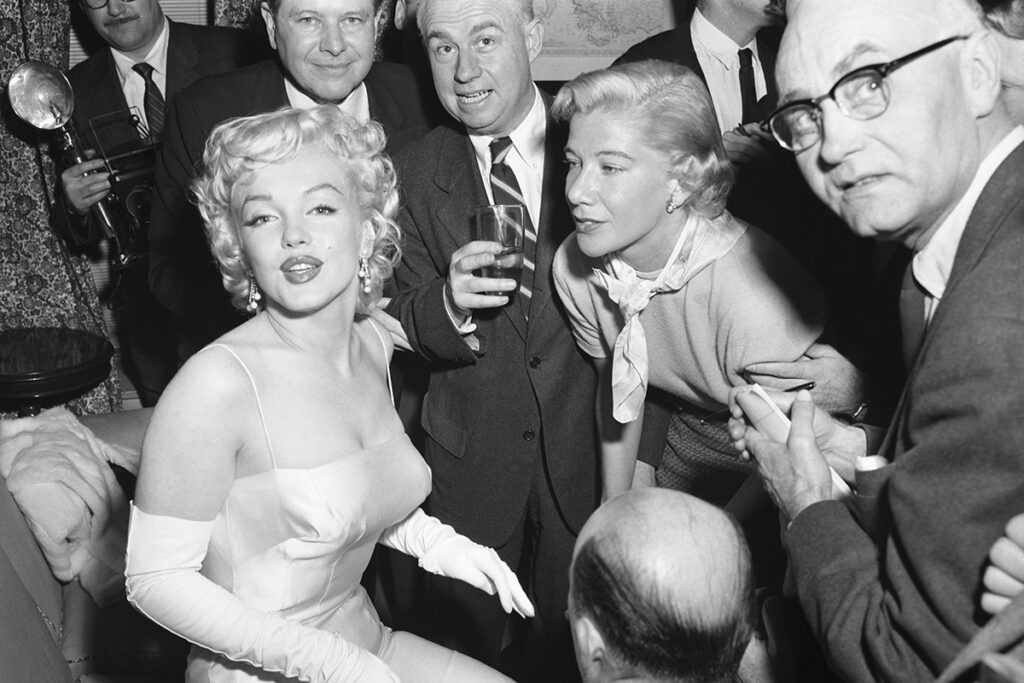 Marilyn Monroe surrounded by photographers