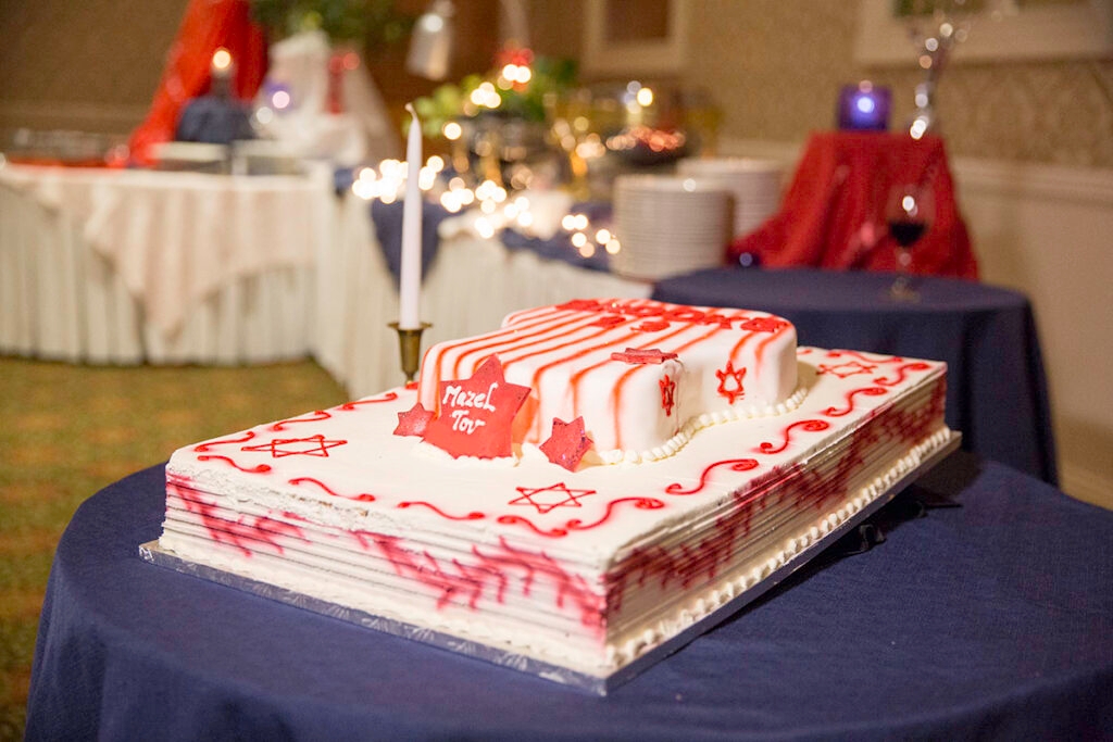 Bar mitzvah cake with one candle and Jewisj decorations