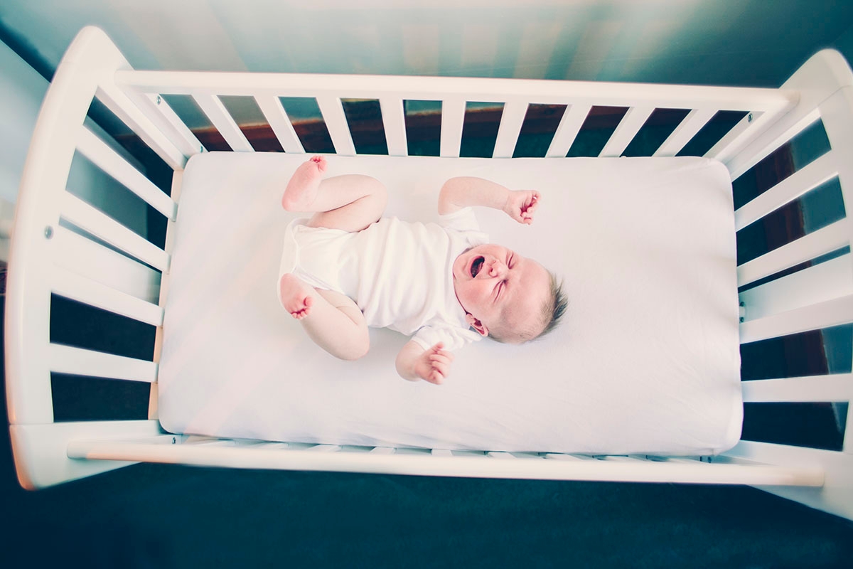 crying baby in a crib