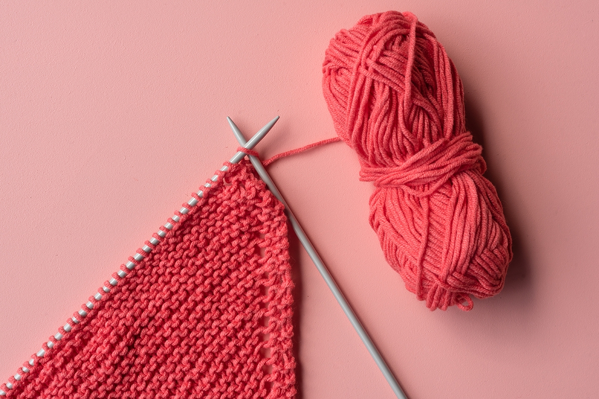 knitting needles and red yarn