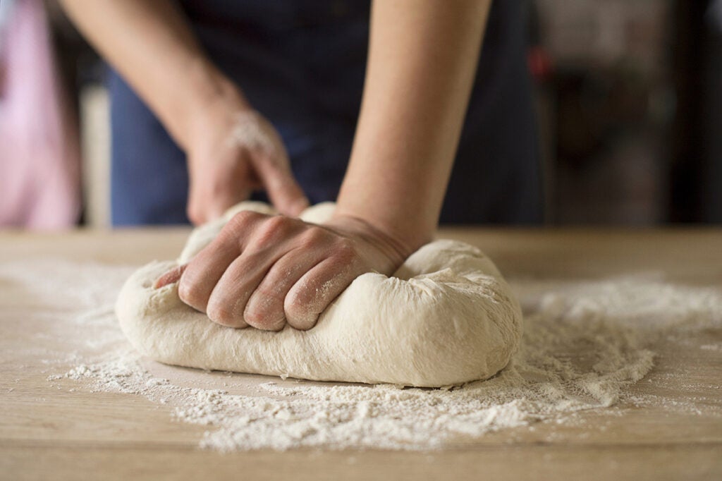 Hands kneading bread dough