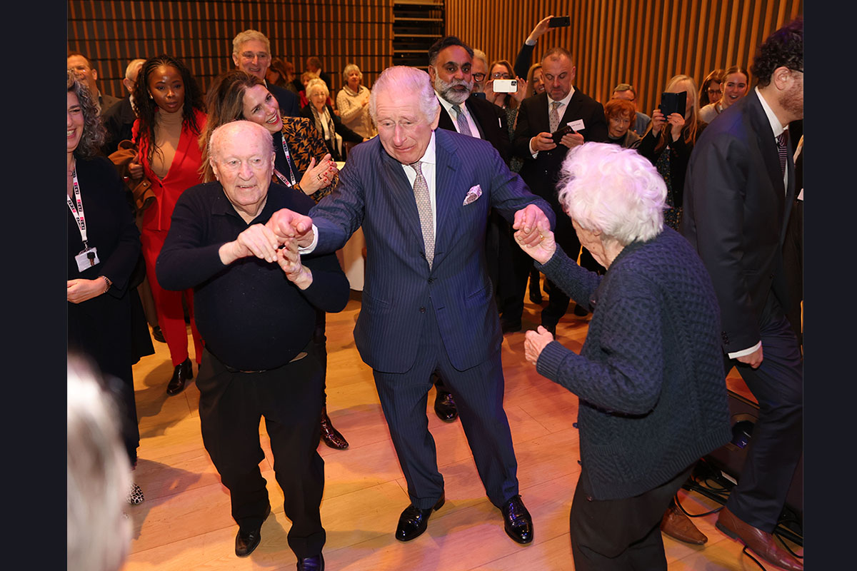 LONDON, ENGLAND - DECEMBER 16: King Charles III dances at a pre-Chanukah reception hosted on site for Holocaust survivors at the JW3 Community Centre on December 16, 2022 in London, England. Founded by Dame Vivien Duffield DBE, JW3 opened in October 2013 with a vision of a vibrant, diverse, unified British-Jewish community, inspired by and engaged with Jewish arts, culture, learning and life.