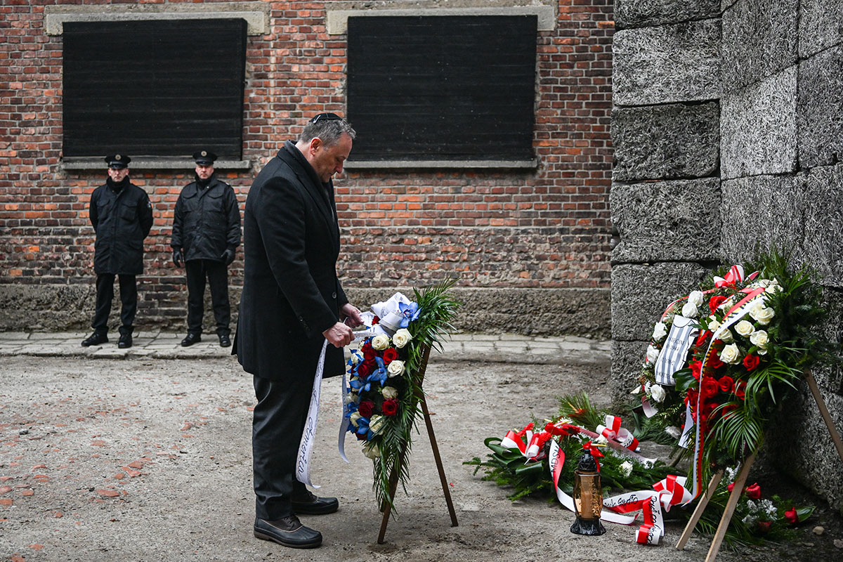 OSWIECIM, POLAND - JANUARY 27: U.S. Second Gentleman, Douglas Emhoff, lays wreaths honoring victims of the Nazi regime by the death wall during the Holocaust Remembrance Day at the former Auschwitz I site on January 27, 2023 in Oswiecim, Poland. International Holocaust Remembrance Day, 27 January, is observed on the anniversary of the liberation of Auschwitz-Birkenau, the largest Nazi death camp (Photo by Omar Marques/Getty Images)