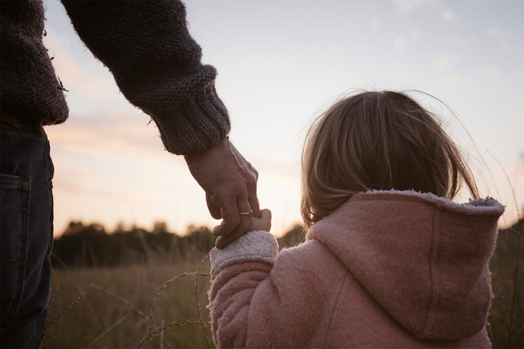 parent holding kids hand