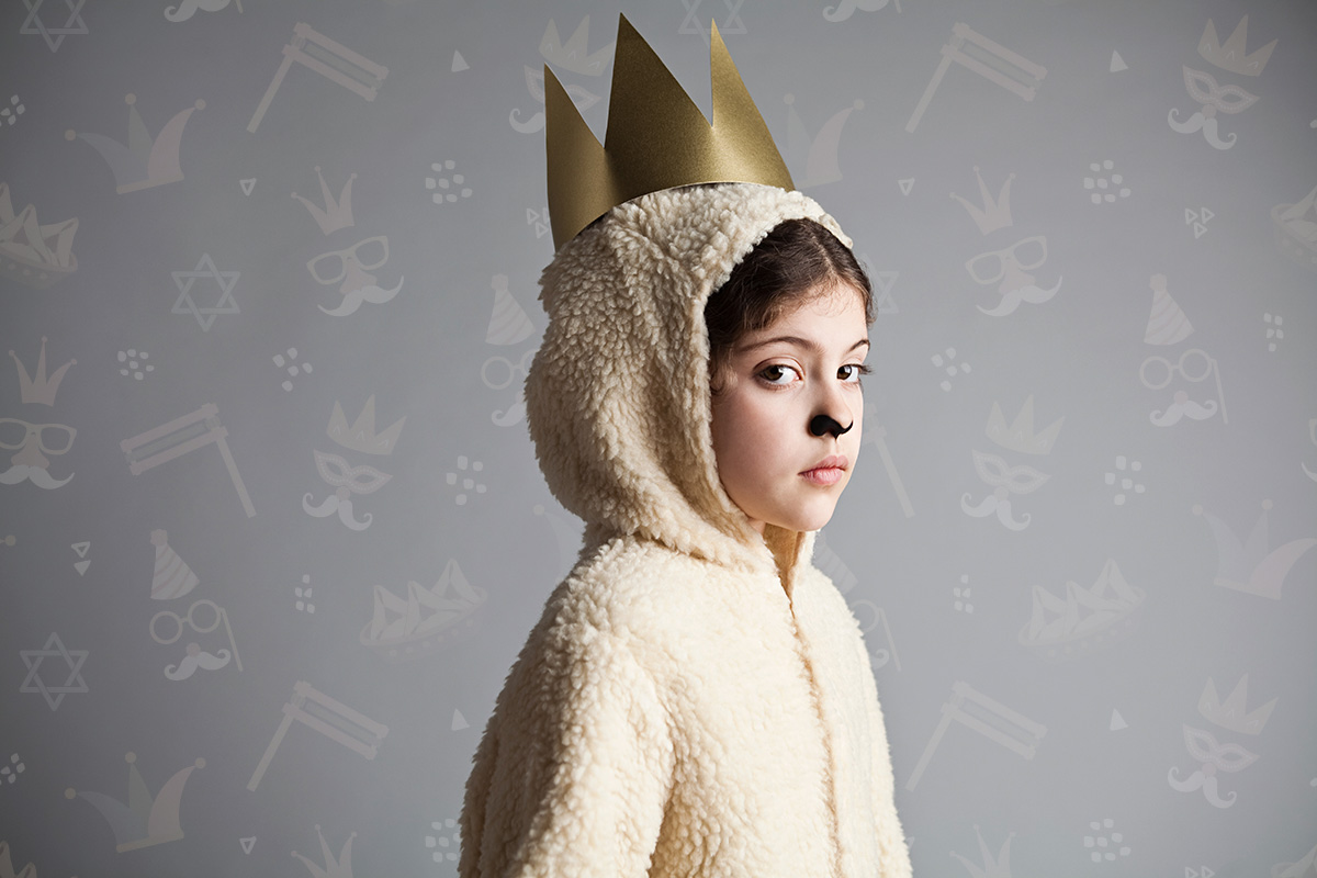 Young girl dressed up as sheep, wearing gold crown