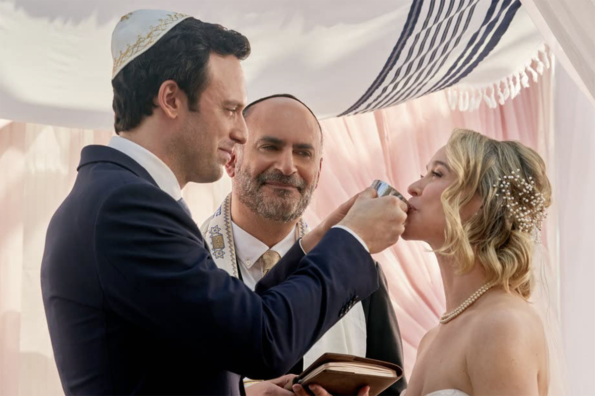 Jake Epstein and Becca Tobin under the chuppah in a scene from Hallmark's "The Wedding Contract"