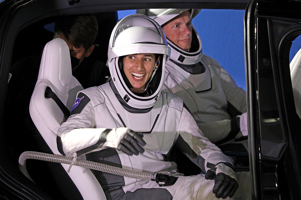 NASA astronaut Jasmin Moghbeli waves from a car as she departs the Neil A. Armstrong Operations and Checkout Building for Launch Complex 39A to board the SpaceX Dragon spacecraft for the Crew-7 mission launch, at NASA's Kennedy Space Center in Florida, on August 26, 2023. The SpaceX Crew-7 mission to the International Space Station, scheduled to launch on August 26, 2023, will mark the seventh operational flight of a Crew Dragon spacecraft and the eleventh overall crewed orbital flight.