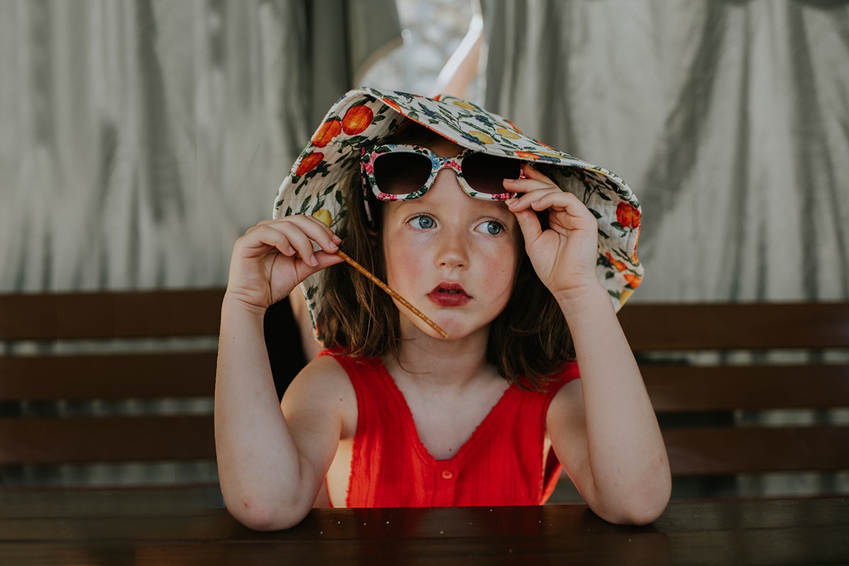 Portrait of a little girl wearing a sunhat and sunglasses