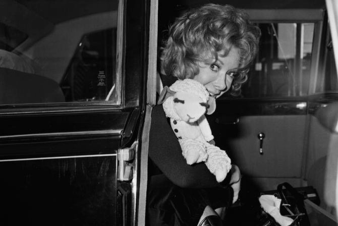 A black and white photo of Shari Lewis and her puppet, Lamb Chop