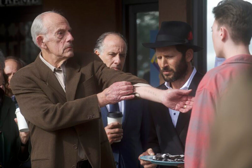 Christopher Llyod plays Holocaust survivor Sol, shows his tattoo from Auschwitz to a young Neo-Nazi.