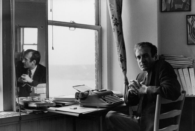 Portrait of Romanian-born Nobel laureate, author, and Holocaust survivor Elie Wiesel as he sits at a typewriter, 1960s.