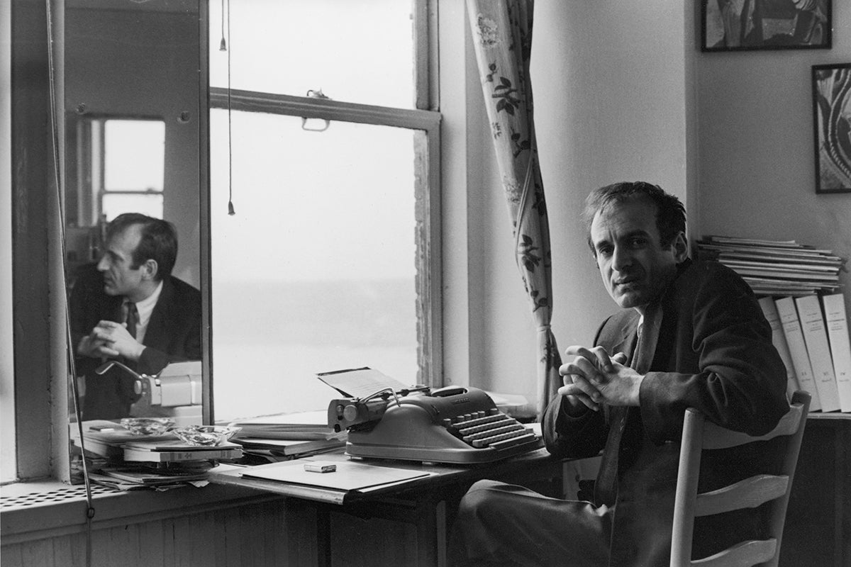 Portrait of Romanian-born Nobel laureate, author, and Holocaust survivor Elie Wiesel as he sits at a typewriter, 1960s.