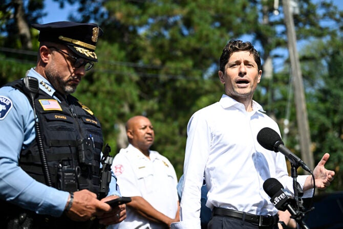 Minneapolis Mayor Jacob Frey (R) speaks to the media following a mass shooting at Annunciation Catholic School on August 27, 2025 in Minneapolis, Minnesota. According to Minneapolis Police, a gunman fired through the windows of the Annunciation Church at worshippers sitting in pews during a Catholic school Mass, killing two children and injuring at least 17 others. The gunman reportedly died at the scene from a self-inflicted gunshot wound.