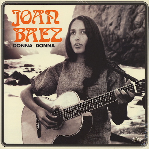 Album cover for Joan Baez's cover of Donna Donna. A black and white photo of Joan, guitar in hand, on a rocky coastline staring off into the distance.