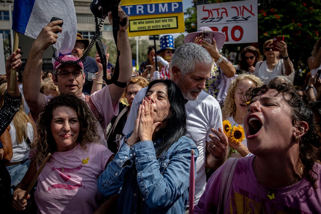 TEL AVIV, ISRAEL - OCTOBER 09: Einav Zangauker (blue shirt), the mother of hostage Matan Zangauker, celebrates as people react to the news of the Gaza peace deal at Hostages Square on October 09, 2025 in Tel Aviv, Israel. Overnight, the US president announced that Israel and Hamas had agreed to the first phase of a ceasefire plan that would see the release of hostages - held in Gaza after their capture on Oct. 7, 2023 - in the coming days. Israel's government is meeting today to formally approve the deal.